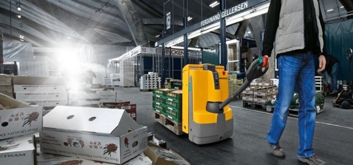 The man handling yellow color Electric pallet truck