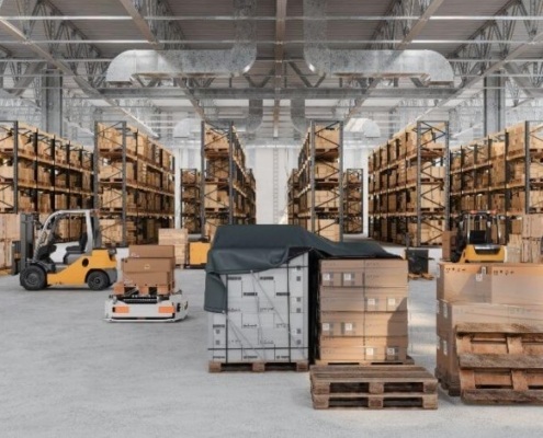 Forklifts in warehouse with lined pallet aisles by Miami Industrial Trucks