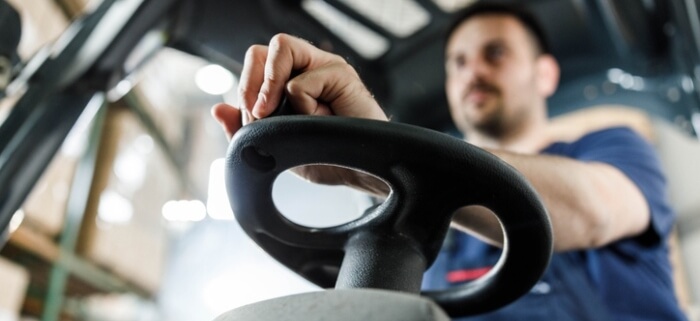 A Close-up view of a warehouse worker driving a forklift in Dayton, OH