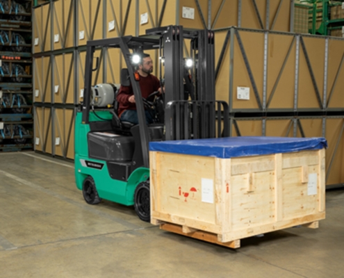 man-working-a-forklift Worker operating a forklift to transport a crate on National Forklift Safety Day in Dayton, OH