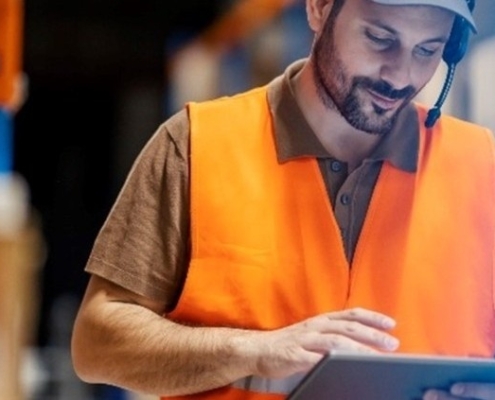Warehouse supervisor reviewing an issue on a tablet