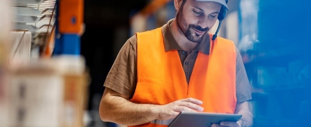Warehouse supervisor reviewing an issue on a tablet