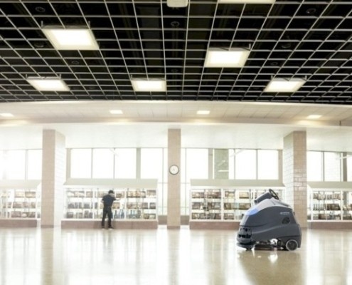 Industrial floor cleaning equipment in warehouse facility