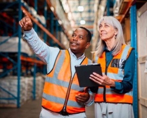 people-in-safety-vests Warehouse workers wearing safety vests in industrial facility