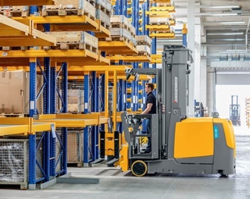 person-driving-forklift Person operating a forklift inside a warehouse